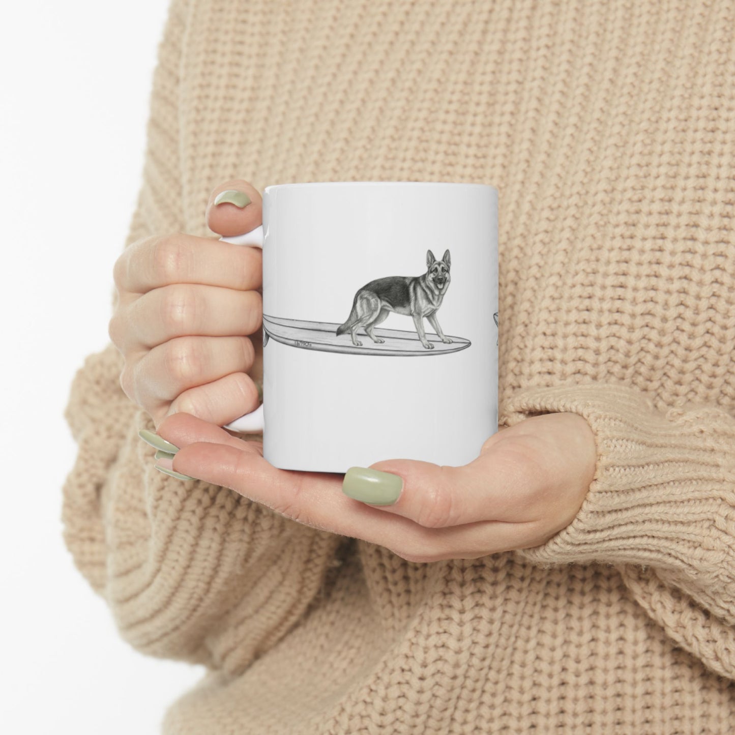 White mug with a graphic of a German Shepherd dog hanging twenty on a long surfboard on a white background.
