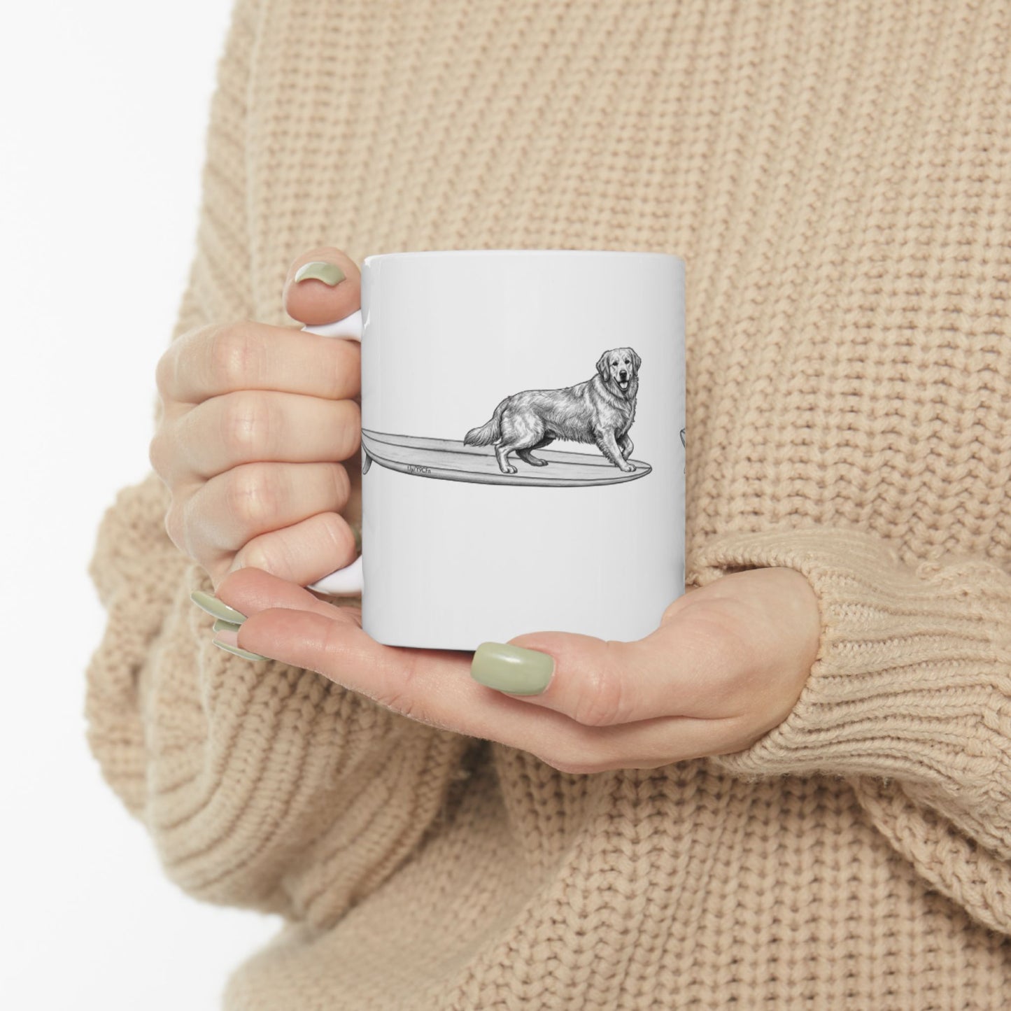 White mug with a black and white illustration of a Golden Retriever on a surfboard, on a white background
