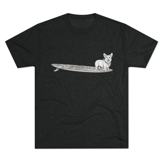 Black tshirt with a Corgi on a tiki art longboard with a hibiscus in it's ear and a hibiscus bandana around it's neck on a black background.