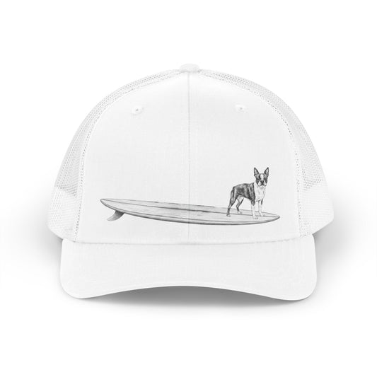 White cap with a Boston Terrier on a longboard surfboard on a white background