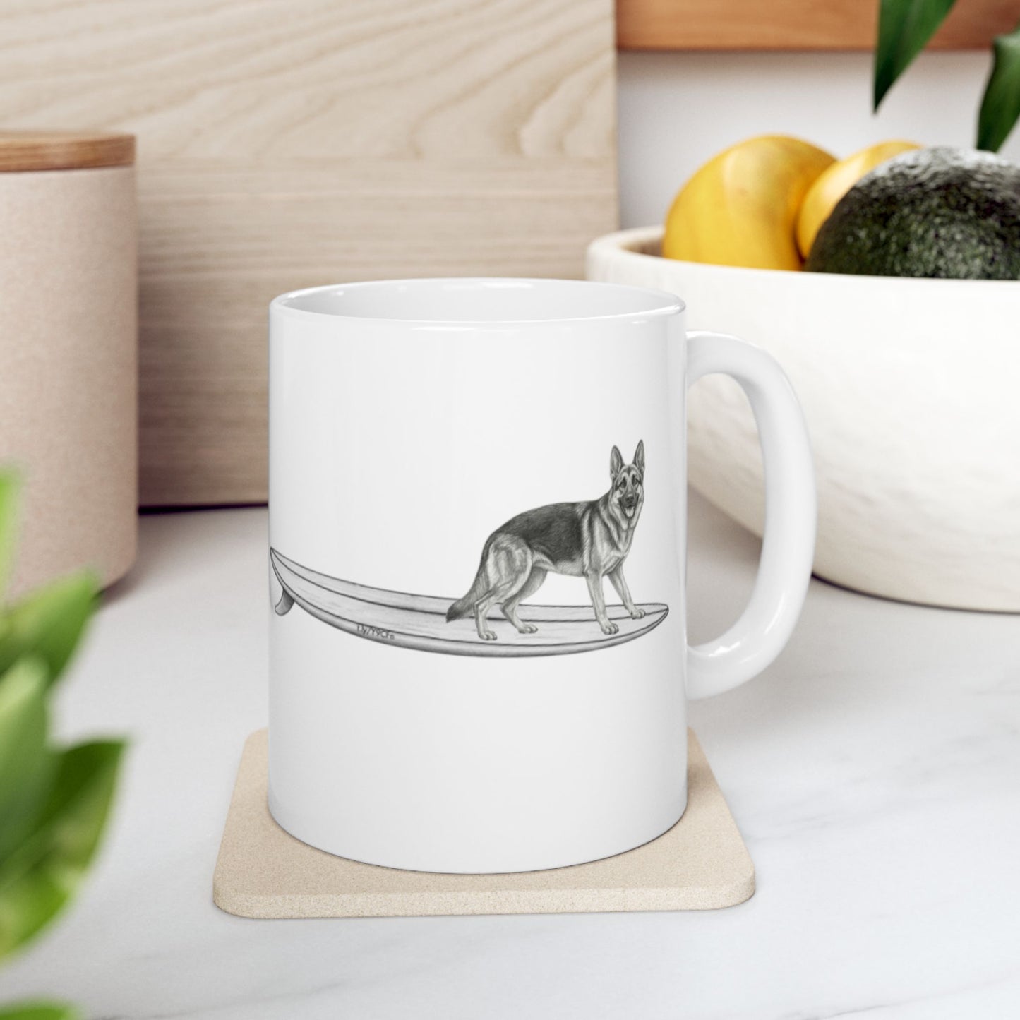 White mug with a graphic of a German Shepherd dog hanging twenty on a long surfboard on a white background.