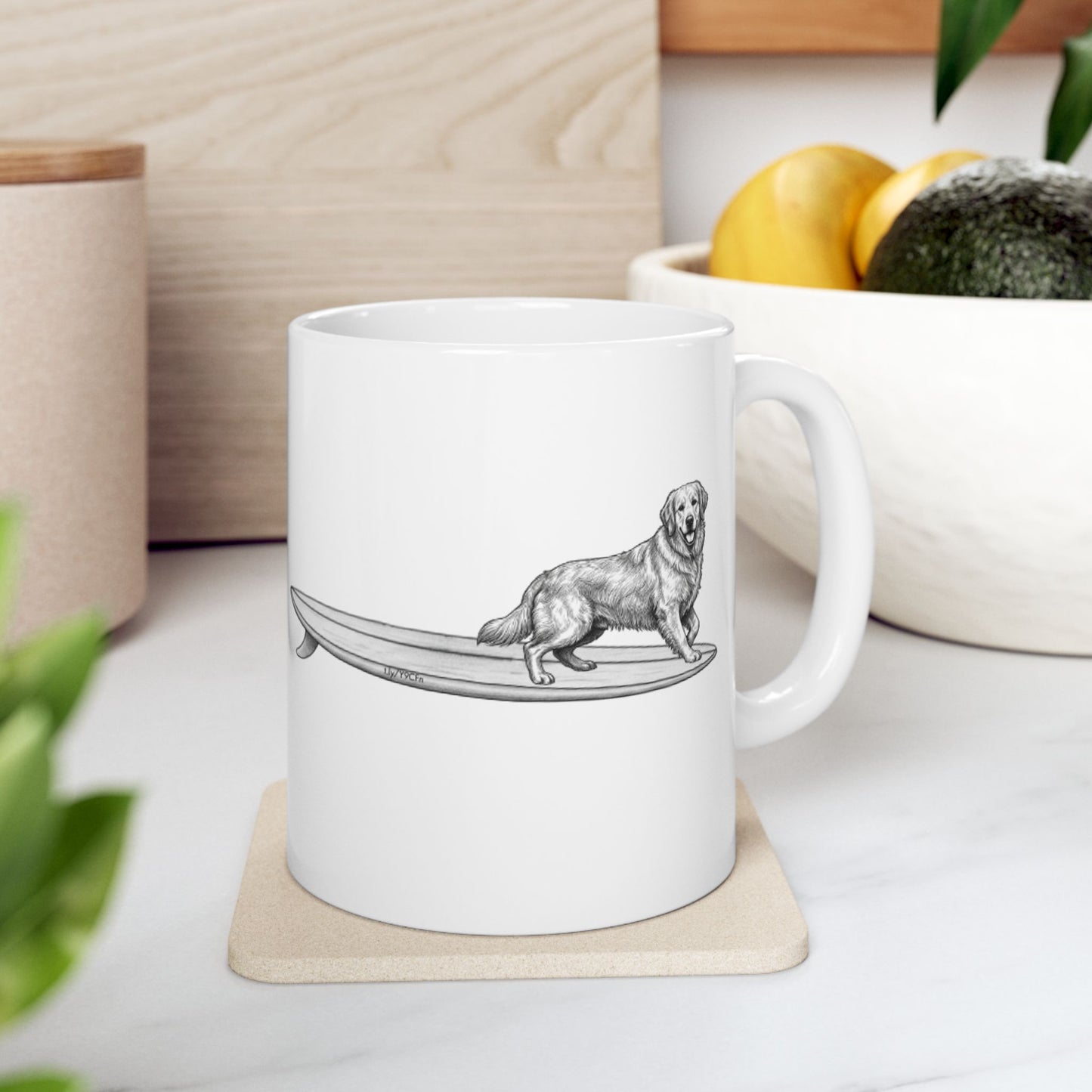 White mug with a black and white illustration of a Golden Retriever on a surfboard, on a white background