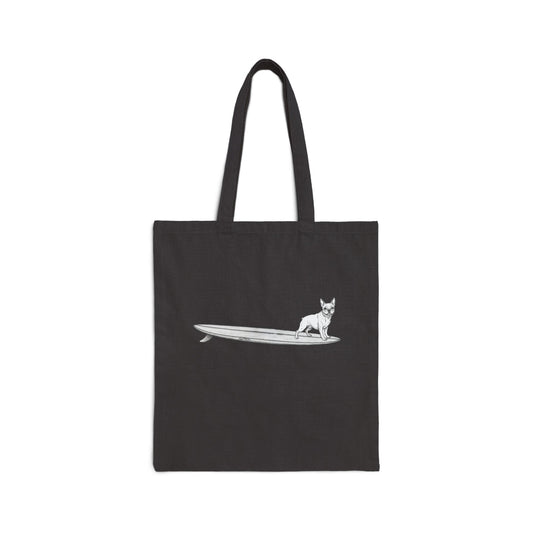 Black tote bag with a French Bulldog on a surfboard design on a black background