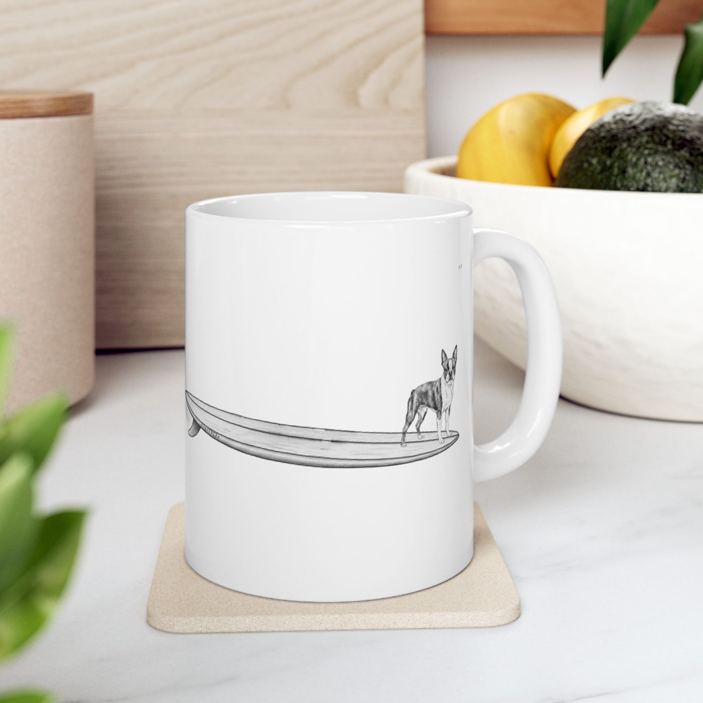 White mug with a black and white graphic of a Boston Terrier on a surfboard  on a white background