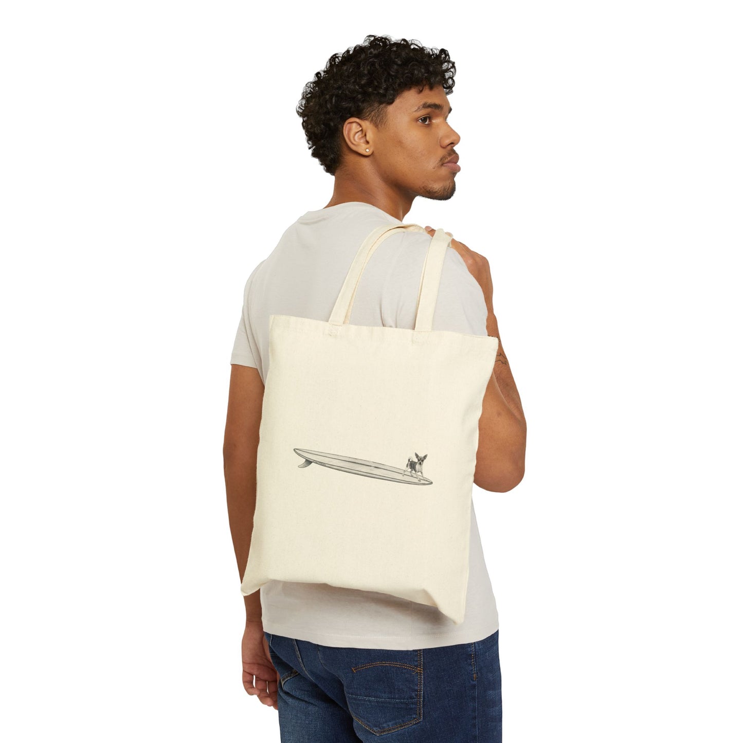 Man carrying a beige tote bag with chihuahua on a longboard with a white background