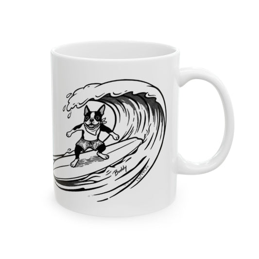 White mug with a black and white graphic of a Boston Terrier surfing on a big wave with a white background.