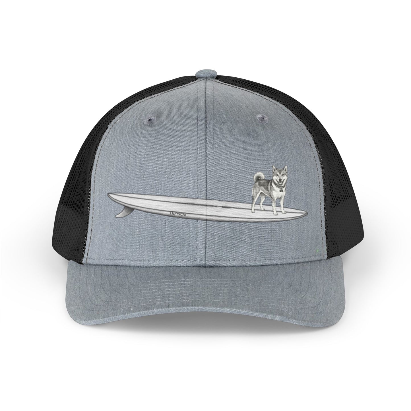 Gray and black mesh trucker hat with a graphic of a Shiba Inu dog hanging twenty on a long  surfboard design on a gray background