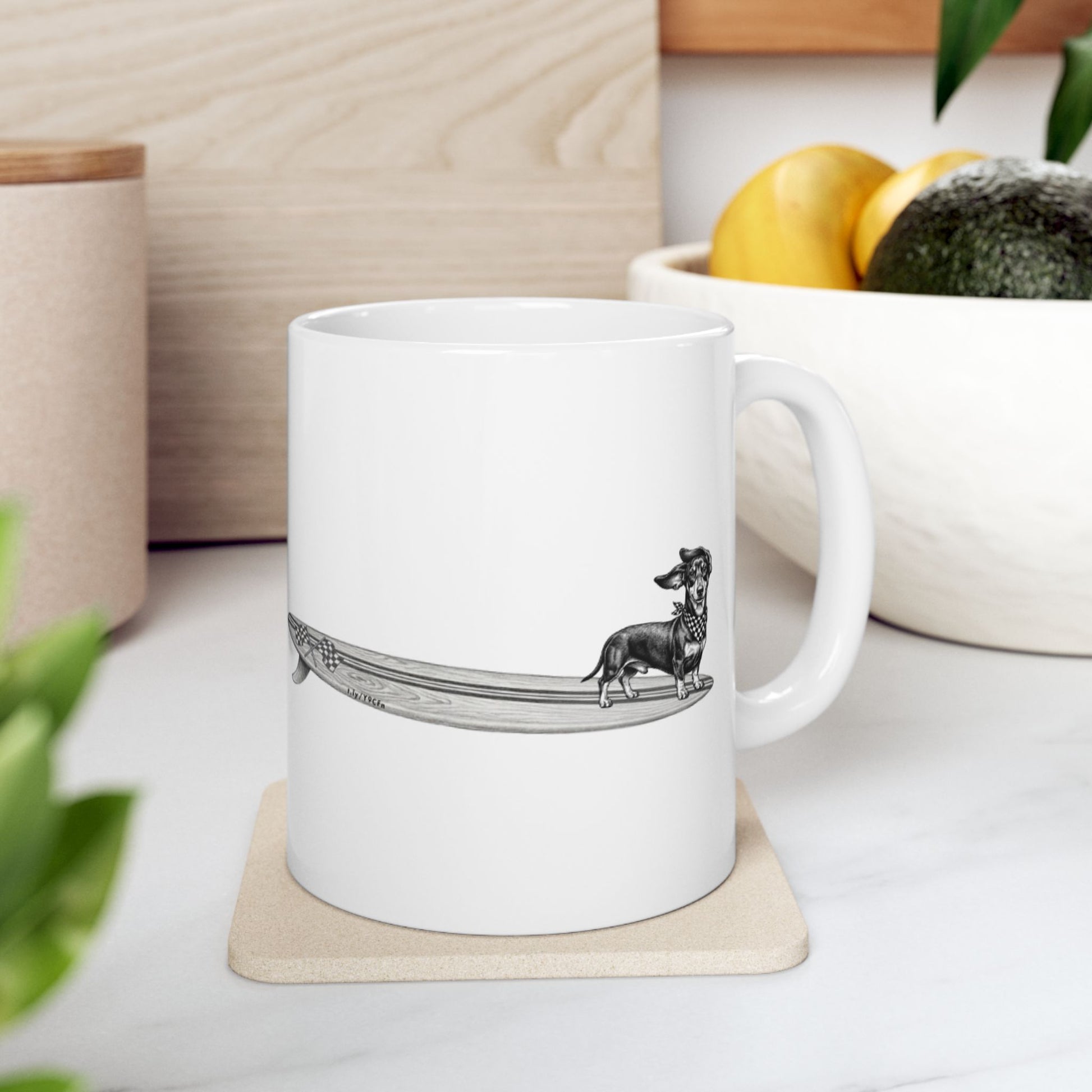 White mug with a black and white illustration of a white mug with a dachshund with a checkered scarf hanging twenty on a surfboard graphic with checkered racing flags on a white background 