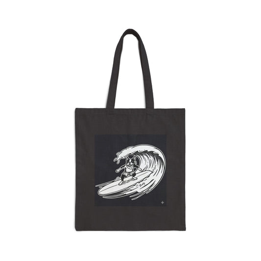 Black tote bag with a graphic of a boston terrier riding a big wave on a longboard with a black background.