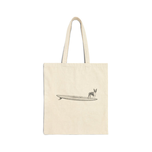 Beige tote bag with a Boston Terrier on a longboard surfboard design on a white background