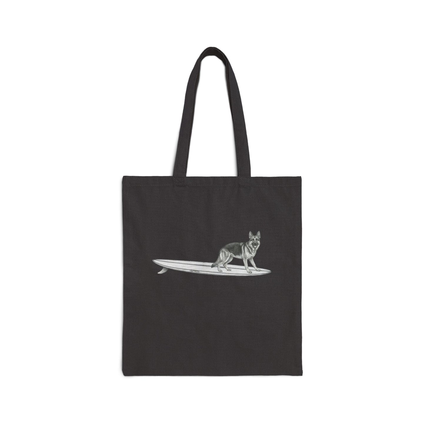 Black tote bag with a graphic of a German Shepherd dog hanging twenty on a long surfboard on a black background.