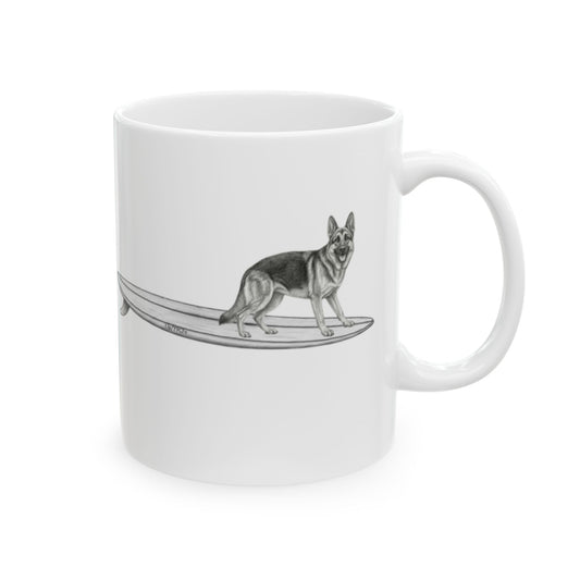 White mug with a graphic of a German Shepherd dog hanging twenty on a long surfboard on a white background.