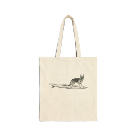 Beige tote bag with a graphic of a German Shepherd dog hanging twenty on a long surfboard on a beige background.