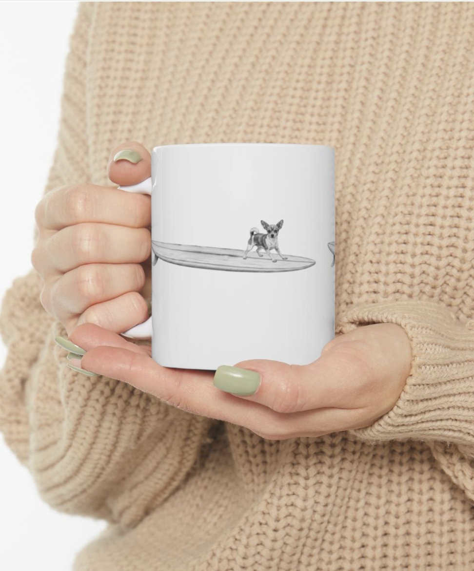 White mug with a design of a chihuahua on a longboard on a white background.